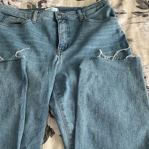 Stylish Light Blue Women's Straight Leg Jeans. With Frenzied hem. Small rips.